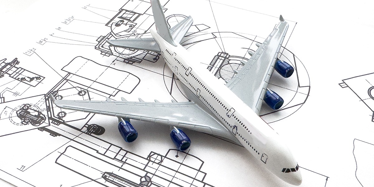 Image of passenger airplane and engineering blueprint