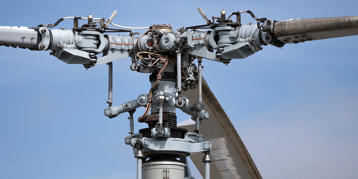 The mechanism of military helicopter rotor on the background of blue sky